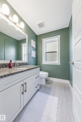 White shaker vanity with granite countertop, undermount sink, and chrome faucet - 76 Dunlop Wynd, Leduc, AB - Indoor Photo Showing Bathroom