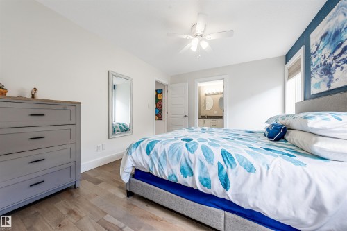 Recessed window, wood-finish flooring, ceiling fan, and white walls - 76 Dunlop Wynd, Leduc, AB - Indoor Photo Showing Bedroom