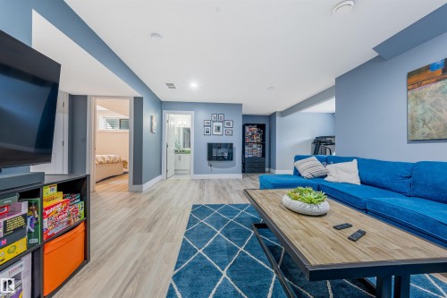 Recessed lighting, light wood-finish flooring, and multiple doorways leading to additional rooms - 76 Dunlop Wynd, Leduc, AB - Indoor Photo Showing Living Room With Fireplace
