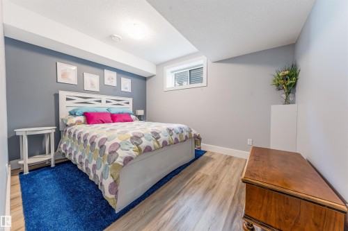 Recessed lighting, wood-finish flooring, and white trim - 76 Dunlop Wynd, Leduc, AB - Indoor Photo Showing Bedroom