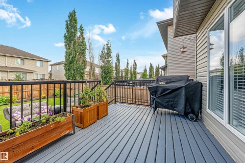 Exterior deck featuring gray plank flooring, black metal railings, and a large window - 76 Dunlop Wynd, Leduc, AB - Outdoor With Deck Patio Veranda With Exterior