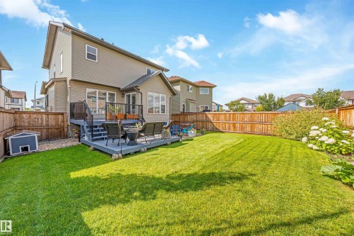 Expansive backyard featuring a manicured lawn, a multi-level deck, and a wood privacy fence - 76 Dunlop Wynd, Leduc, AB - Outdoor