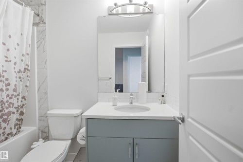 White paneled door with brushed nickel hardware - 3877 Chrustawka Place Sw, Edmonton, AB - Indoor Photo Showing Bathroom
