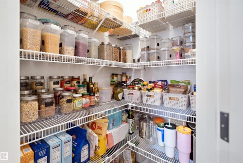 Corner pantry with multiple wire shelving units - 3877 Chrustawka Place Sw, Edmonton, AB - Indoor