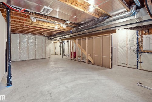 Unfinished basement with concrete flooring, exposed ceiling joists, and framed partition walls - 3877 Chrustawka Place Sw, Edmonton, AB - Indoor Photo Showing Basement