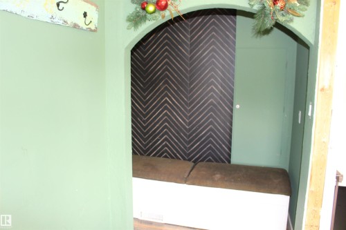 Recessed arched alcove featuring a herringbone accent wall and built-in bench - 49480 Rge Rd 41, Rural Leduc County, AB - 