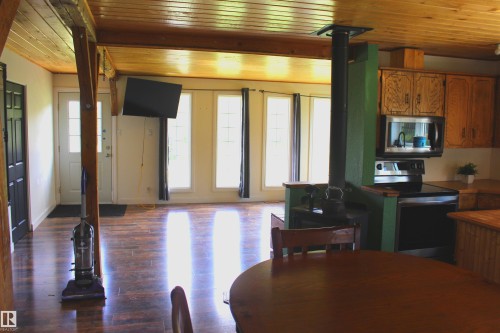 Wood-finish flooring throughout, wood plank ceiling, and exposed wood beams - 49480 Rge Rd 41, Rural Leduc County, AB - Indoor