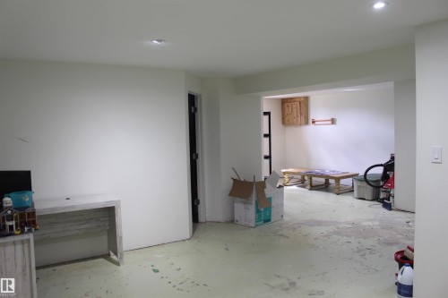 Recessed ceiling lighting, wood-finish flooring, and a built-in wood-finish cabinet - 49480 Rge Rd 41, Rural Leduc County, AB - Indoor