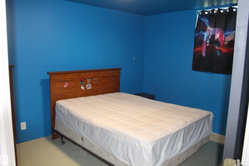 Blue-painted walls with light-colored flooring - 49480 Rge Rd 41, Rural Leduc County, AB - Indoor Photo Showing Bedroom