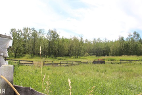 Expansive natural landscape featuring a wooden fence line and dense tree coverage - 49480 Rge Rd 41, Rural Leduc County, AB - Outdoor With View