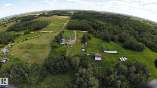 Extensive acreage featuring multiple structures, open fields, and dense mature trees - 49480 Rge Rd 41, Rural Leduc County, AB - Outdoor With View