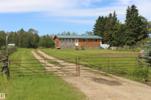 Wood-sided property with a metal roof and a stone foundation - 49480 Rge Rd 41, Rural Leduc County, AB - Outdoor