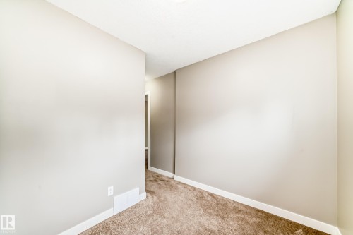 Neutral-toned interior room featuring light-colored walls and plush carpeting - 12118 125 Street Nw, Edmonton, AB - Indoor Photo Showing Other Room