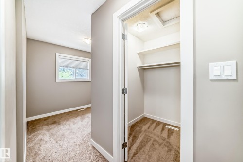 Interior hallway featuring a built-in closet with shelving and hanging rod - 12118 125 Street Nw, Edmonton, AB - Indoor Photo Showing Other Room
