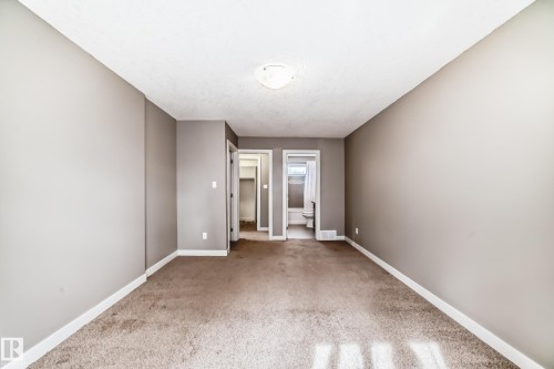 Carpeted room with neutral tone walls and white baseboards - 12118 125 Street Nw, Edmonton, AB - Indoor Photo Showing Other Room