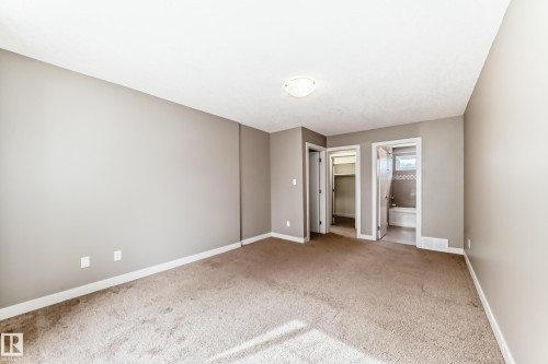 Carpeted room with neutral wall tones and white baseboards - 12118 125 Street Nw, Edmonton, AB - Indoor Photo Showing Other Room