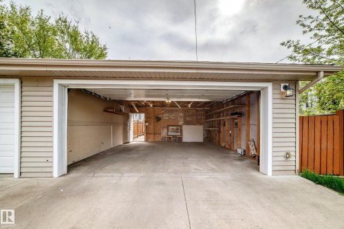 Two-car garage with concrete driveway and neutral-toned siding - 12118 125 Street Nw, Edmonton, AB - Outdoor With Exterior