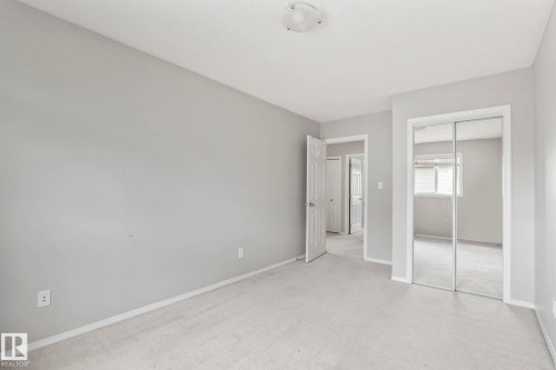 Neutral wall finishes and carpet flooring - #80 4350 23St Nw, Edmonton, AB - Indoor Photo Showing Other Room