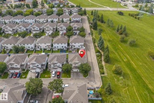 Residential neighborhood with uniform housing architecture, street parking, and manicured green spaces - #80 4350 23St Nw, Edmonton, AB - Outdoor With View