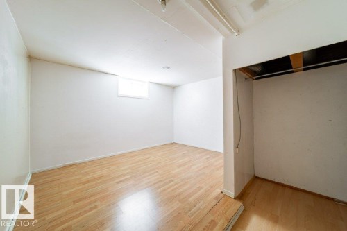 Hardwood-finish flooring, recessed lighting, and a window for natural light - 7812 128 Avenue Nw, Edmonton, AB - Indoor Photo Showing Other Room