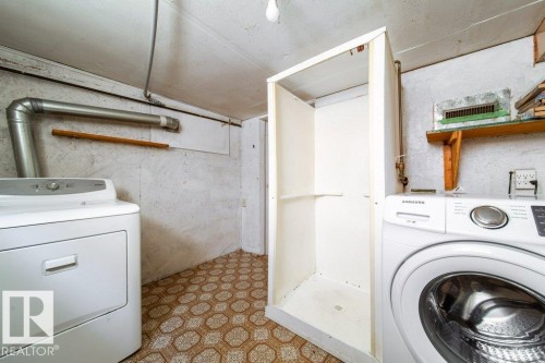 Laundry area featuring a shower stall, patterned flooring, and an overhead light fixture - 7812 128 Avenue Nw, Edmonton, AB - Indoor Photo Showing Laundry Room