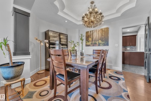 Tray ceiling with an ornate chandelier - 10915 175 Avenue Nw, Edmonton, AB - Indoor Photo Showing Dining Room