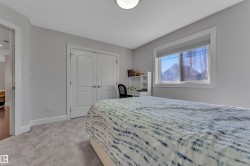 Neutral wall paint, light-toned carpet, double closet doors, white window trim, and overhead lighting - 