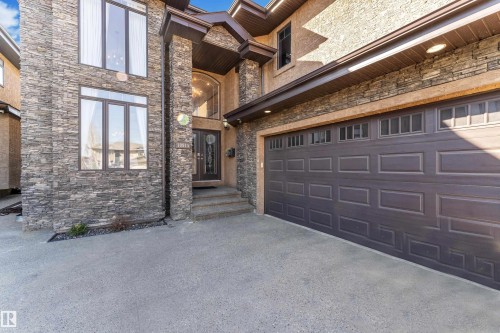 Stone veneer and stucco exterior with an attached two-car garage - 10915 175 Avenue Nw, Edmonton, AB - Outdoor