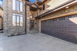 Stone veneer and stucco exterior with an attached two-car garage - 