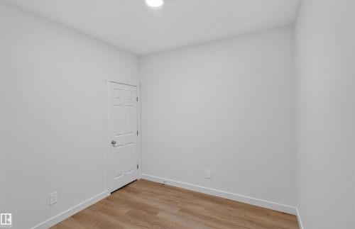 Recessed ceiling lighting, durable wood-finish flooring, and white trim - 1676 27 Street Nw, Edmonton, AB 