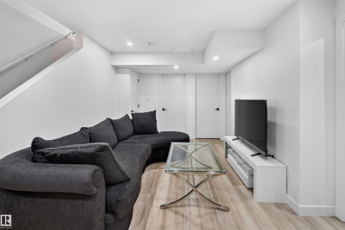 Recessed lighting, wood-finish flooring, and white walls - 1676 27 Street Nw, Edmonton, AB 
