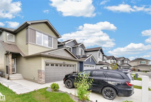 Two-story residence with a two-car garage, stone accents, and varied siding - 1676 27 Street Nw, Edmonton, AB 