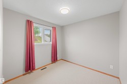 Neutral wall color, carpet flooring, wood trim, flush mount ceiling light, and a window - 