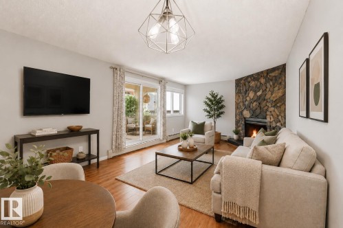 #107 10138 116 St Nw, Edmonton, AB - Indoor Photo Showing Living Room With Fireplace