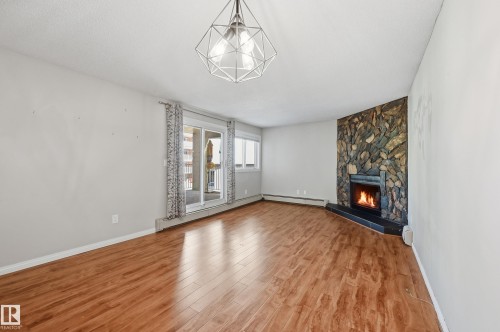 #107 10138 116 St Nw, Edmonton, AB - Indoor Photo Showing Living Room With Fireplace