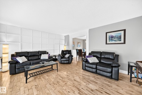 Hardwood flooring, wainscoting wall detail, recessed lighting, and a defined entry to an adjacent dining area - #38 24512 Sturgeon Rd, Rural Sturgeon County, AB 