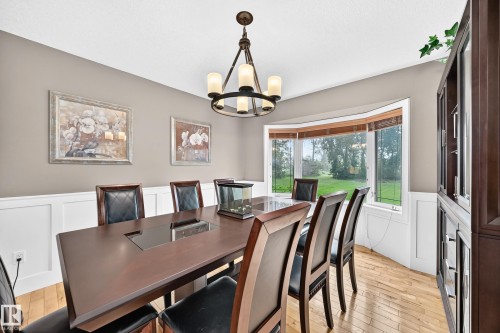 Hardwood flooring, wainscoting, bay window, chandelier lighting, and a built-in display cabinet - #38 24512 Sturgeon Rd, Rural Sturgeon County, AB 