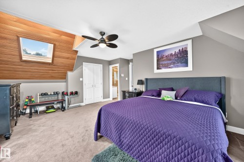 Sloped ceiling with wood-finish paneling and skylight - #38 24512 Sturgeon Rd, Rural Sturgeon County, AB 