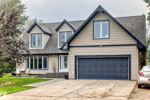 Exterior featuring dormer windows, a two-car garage, and a front entry with a sidelight - #38 24512 Sturgeon Rd, Rural Sturgeon County, AB 