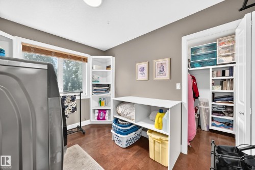 Wood-finish flooring, built-in shelving, and a window with blinds - #38 24512 Sturgeon Rd, Rural Sturgeon County, AB 