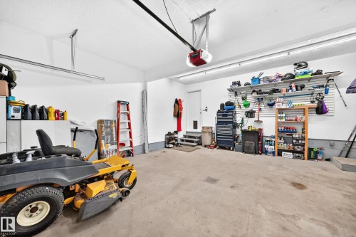 Garage with an automatic door opener and overhead fluorescent lighting - #38 24512 Sturgeon Rd, Rural Sturgeon County, AB 