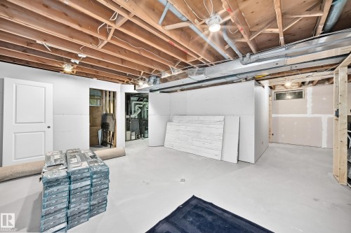 Unfinished basement with exposed ceiling joists, concrete flooring, and partial wall framing - #38 24512 Sturgeon Rd, Rural Sturgeon County, AB 