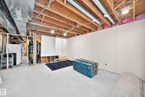 Unfinished lower level featuring exposed wood joists, partial drywall installation, and framed partition walls - #38 24512 Sturgeon Rd, Rural Sturgeon County, AB 