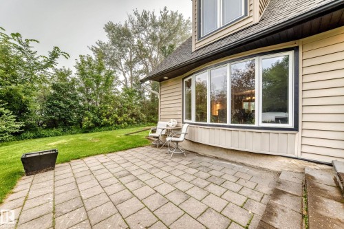 Paved patio area, expansive lawn, and a large bay window - #38 24512 Sturgeon Rd, Rural Sturgeon County, AB 