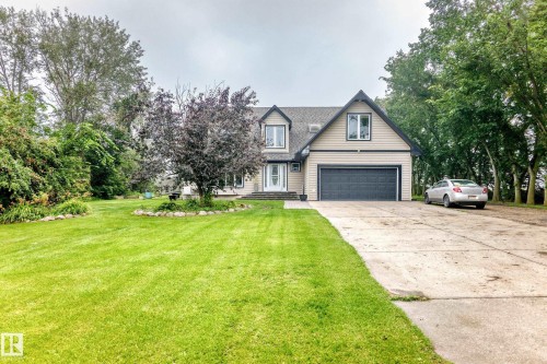 Two-story residence with siding exterior, attached garage, and a concrete driveway - #38 24512 Sturgeon Rd, Rural Sturgeon County, AB 