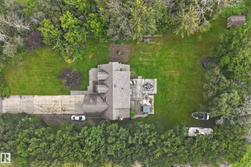 Expansive lot featuring a multi-level roofline, extensive concrete driveway, and a spacious rear deck - #38 24512 Sturgeon Rd, Rural Sturgeon County, AB 