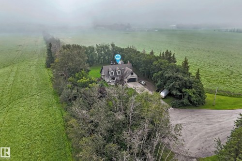 Two-story home featuring a prominent roofline, dormer windows, and an attached two-car garage - #38 24512 Sturgeon Rd, Rural Sturgeon County, AB 