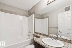 White tub and shower combination with chrome fixtures - 