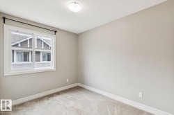 Wall-to-wall carpeting, neutral wall paint, white trim, single window, and a ceiling-mounted light fixture - 
