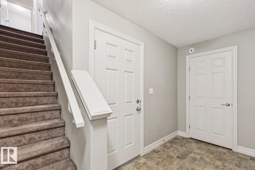 Staircase with carpeted treads and a white painted handrail - 5409 3 Avenue Sw, Edmonton, AB - Indoor Photo Showing Other Room